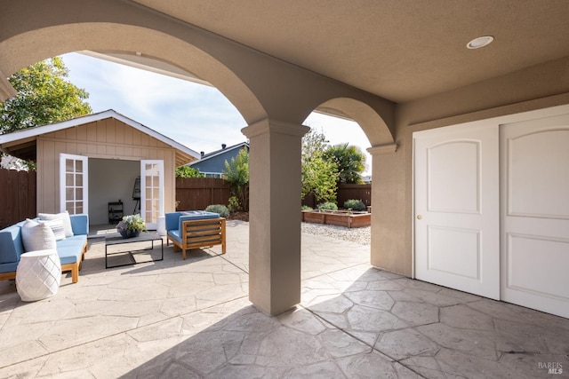 view of patio with a fenced backyard, an outbuilding, and an outdoor hangout area