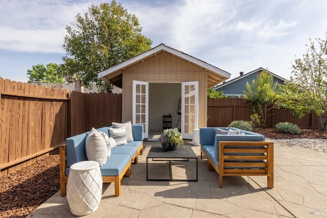 view of patio / terrace with outdoor lounge area, a fenced backyard, and an outdoor structure