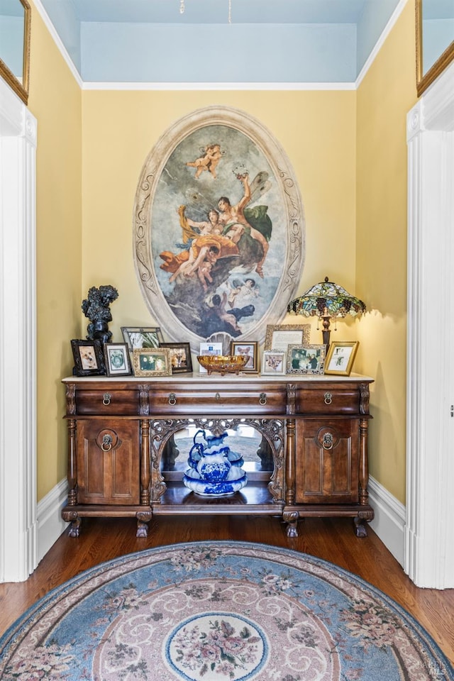 interior space with baseboards and wood finished floors