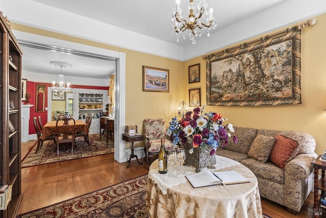 living area with a chandelier and wood finished floors