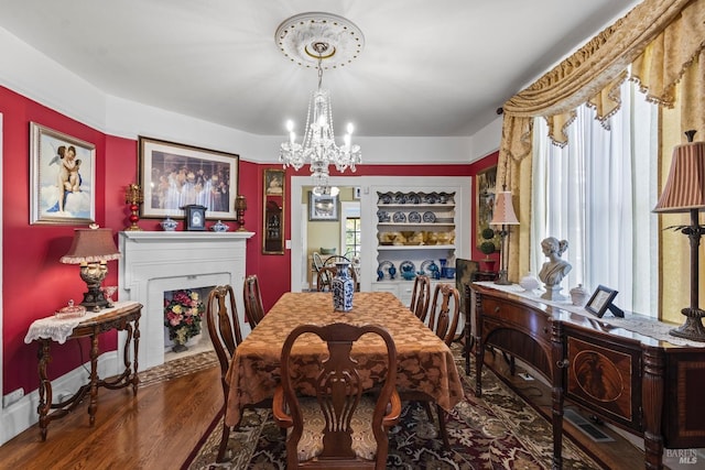 dining area with a chandelier and wood finished floors