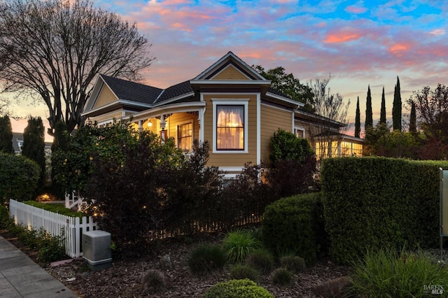 property exterior at dusk with fence