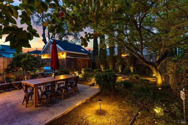 view of patio with outdoor dining area and fence