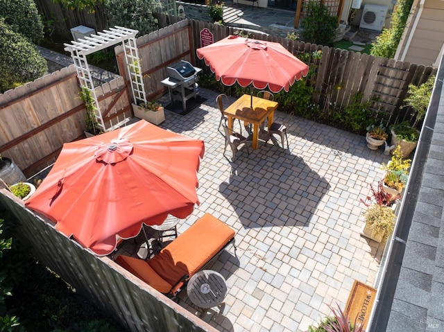 view of patio / terrace with a fenced backyard, outdoor dining space, a grill, and a pergola