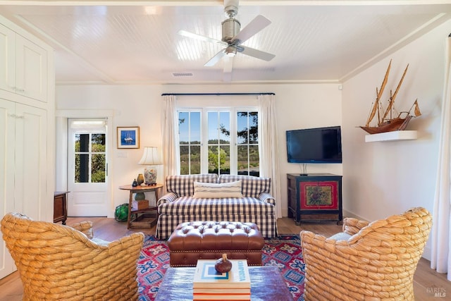 living room with visible vents, ceiling fan, and wood finished floors