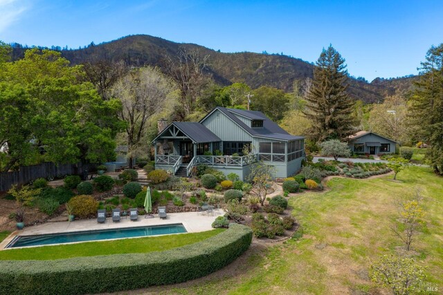 outdoor pool with a patio area and a mountain view