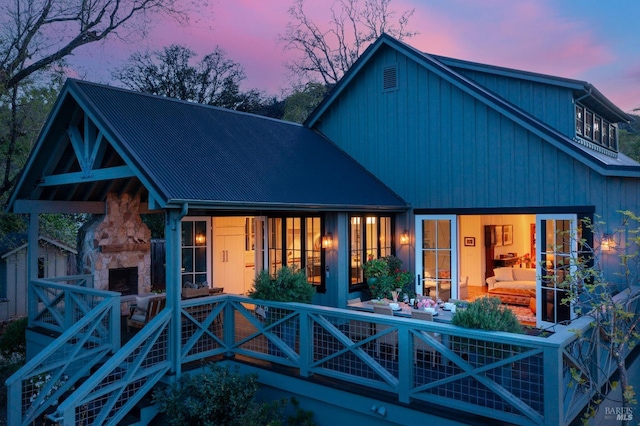 rear view of property with stone siding