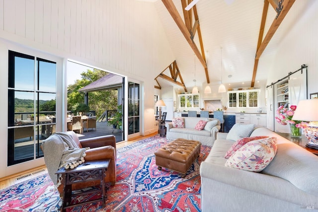living area with high vaulted ceiling, beamed ceiling, and visible vents