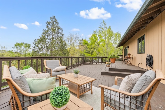 wooden terrace with an outdoor living space