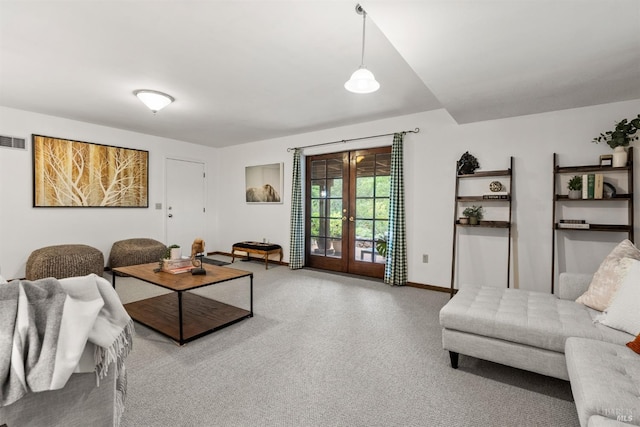 carpeted living room featuring baseboards, french doors, and visible vents