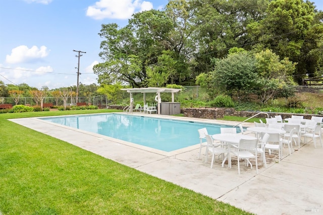 view of swimming pool with a lawn, a patio area, a fenced in pool, and fence
