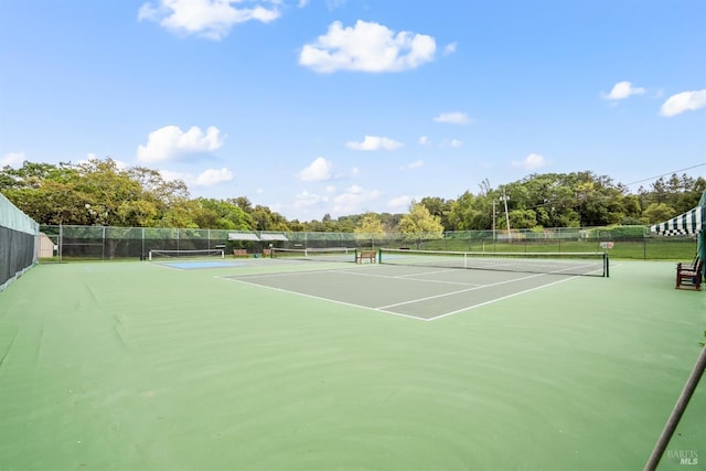 view of sport court featuring fence