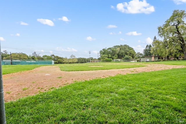 surrounding community featuring a lawn and fence