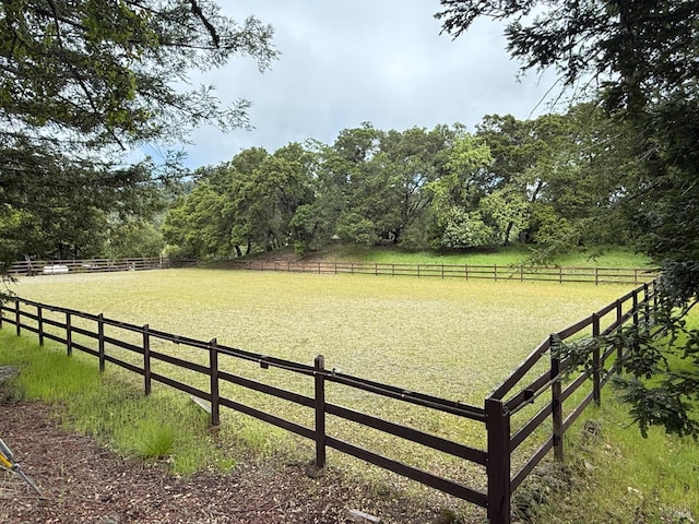view of yard with a rural view and fence