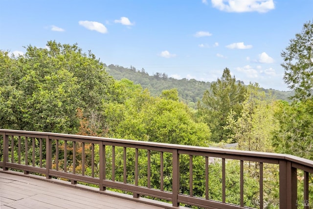 wooden terrace with a view of trees