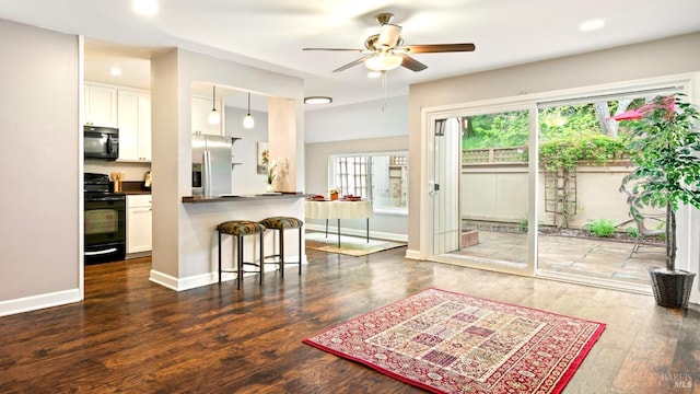interior space featuring recessed lighting, ceiling fan, baseboards, and dark wood-type flooring