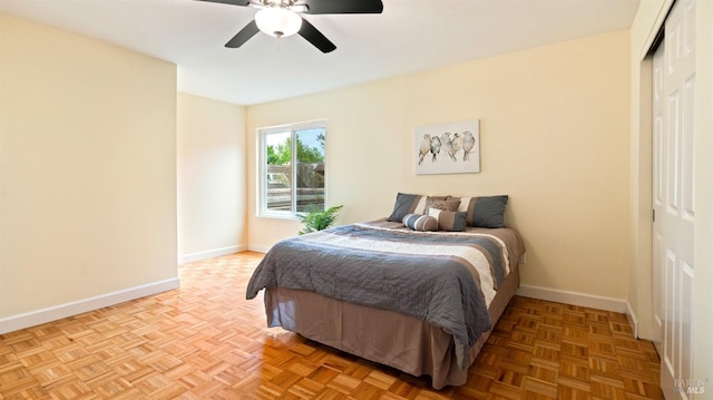 bedroom featuring a closet, baseboards, and ceiling fan