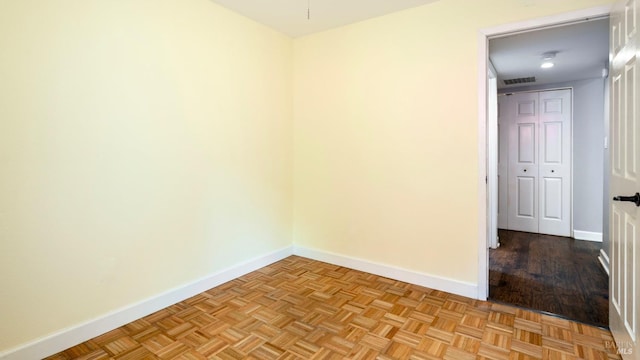 unfurnished room featuring baseboards and visible vents