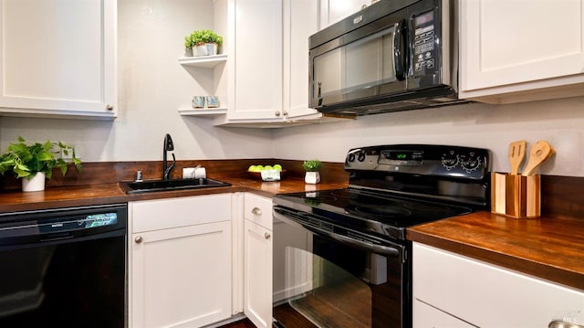 kitchen with white cabinets, open shelves, a sink, butcher block counters, and black appliances
