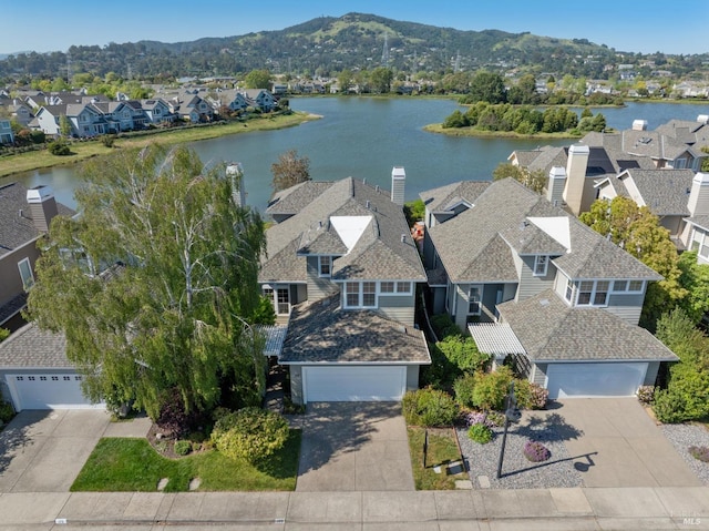 aerial view featuring a water and mountain view and a residential view