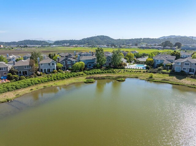 aerial view with a water and mountain view and a residential view
