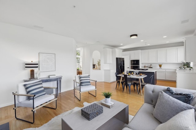 living area featuring light wood finished floors and recessed lighting