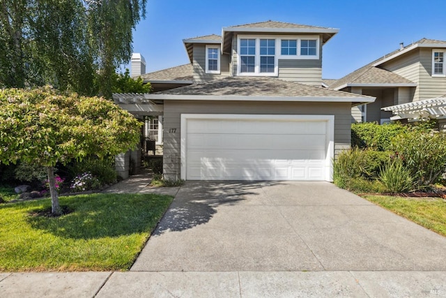 view of front of home with a chimney, a front lawn, concrete driveway, roof with shingles, and a garage