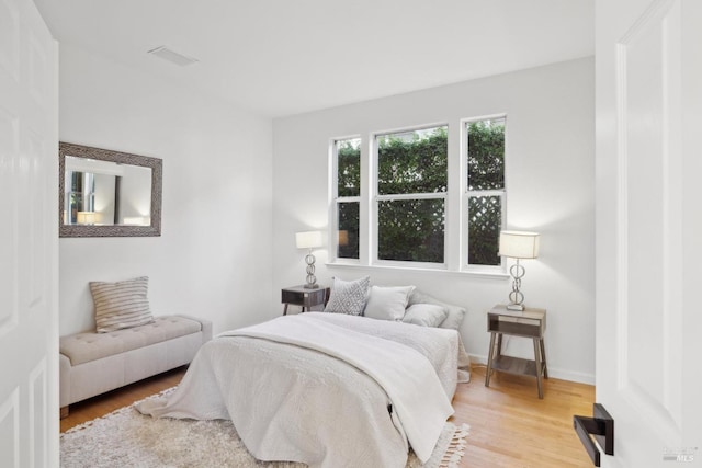 bedroom featuring visible vents and light wood finished floors