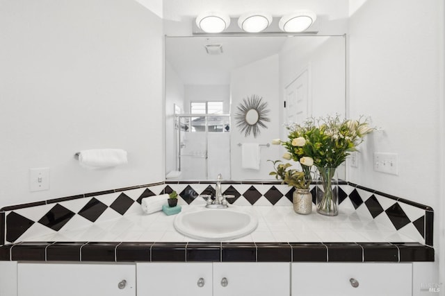 bathroom featuring tasteful backsplash, vanity, and visible vents