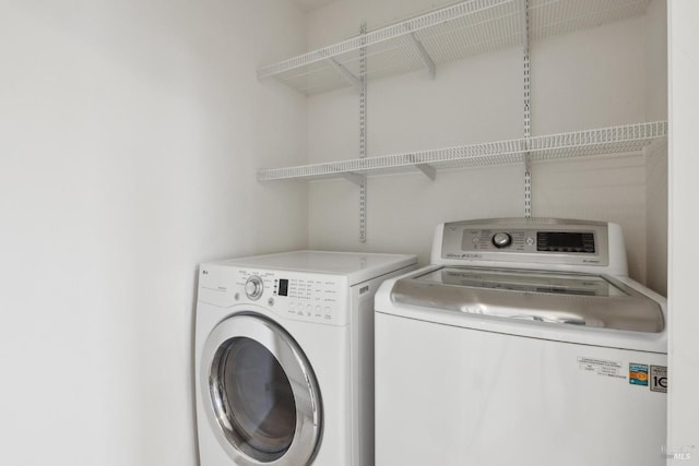 laundry room with washer and clothes dryer and laundry area