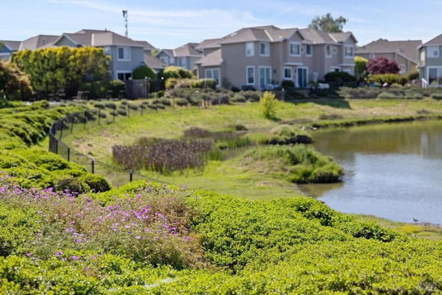 view of water feature featuring a residential view and fence