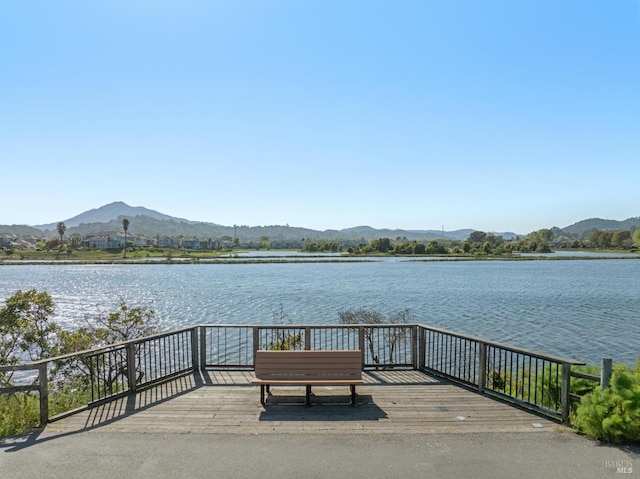 exterior space with a water and mountain view