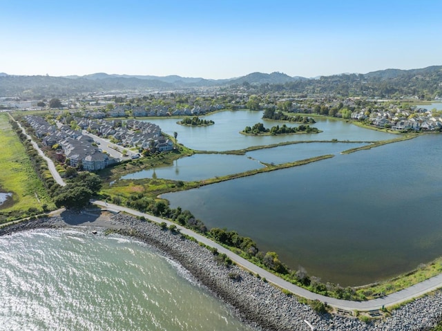 drone / aerial view with a water and mountain view