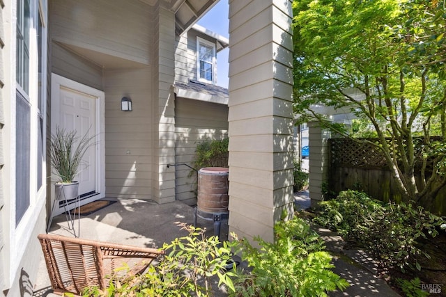 view of exterior entry featuring fence