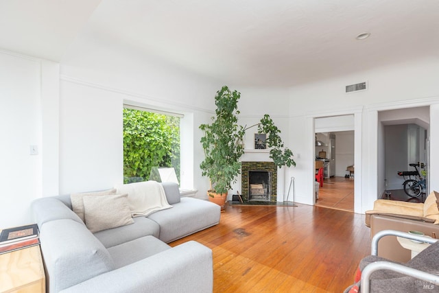 55 Sunshine Ave, Sausalito, CA 94965 - living area featuring wood finished floors, a brick fireplace, and visible vents