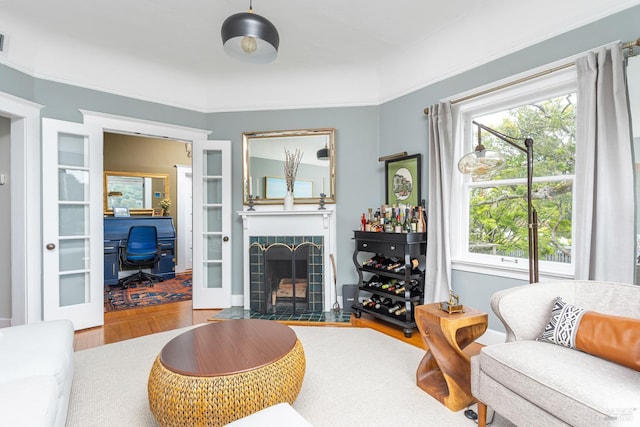 55 Sunshine Ave, Sausalito, CA 94965 - living area with a tiled fireplace, french doors, plenty of natural light, and wood finished floors