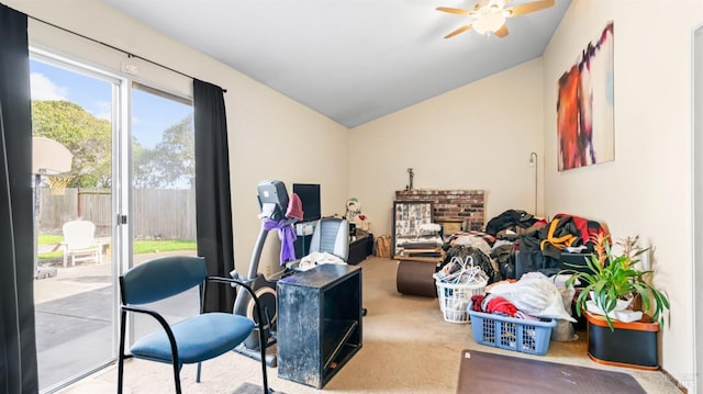 interior space featuring carpet, a fireplace, a ceiling fan, and lofted ceiling