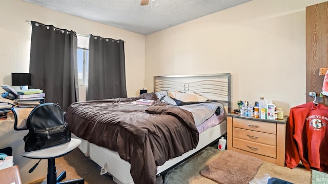 bedroom with a textured ceiling and a ceiling fan