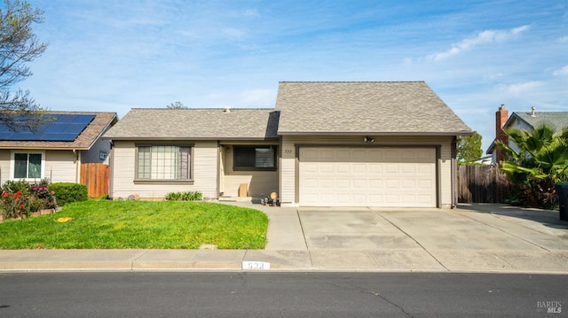 ranch-style home with roof with shingles, fence, a front lawn, an attached garage, and driveway