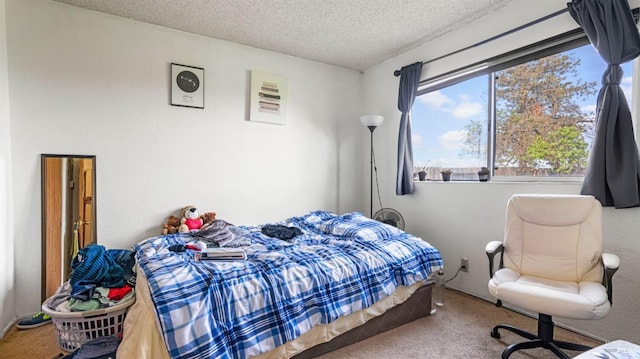 bedroom featuring a textured ceiling and carpet flooring