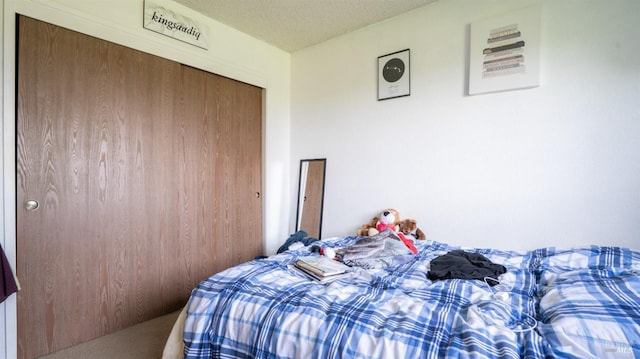 carpeted bedroom with a closet