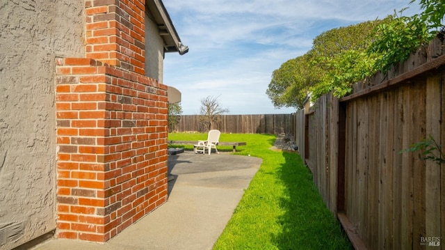 view of yard with a fenced backyard and a patio