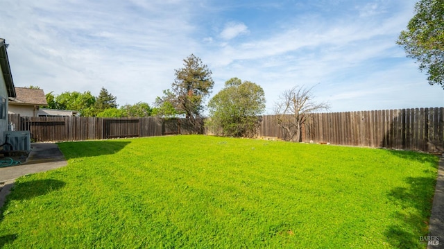 view of yard with cooling unit and a fenced backyard