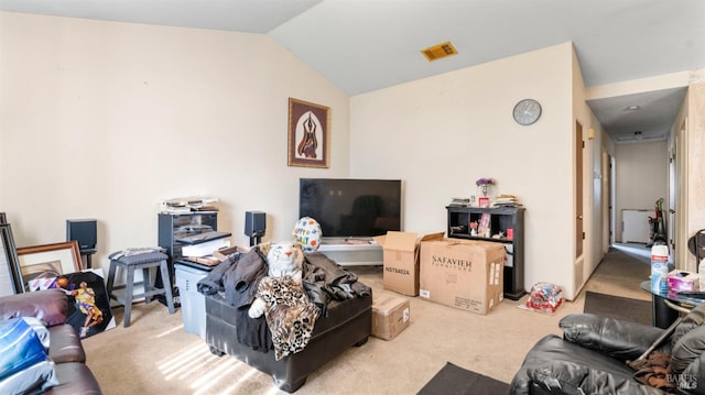 carpeted living area featuring visible vents and lofted ceiling
