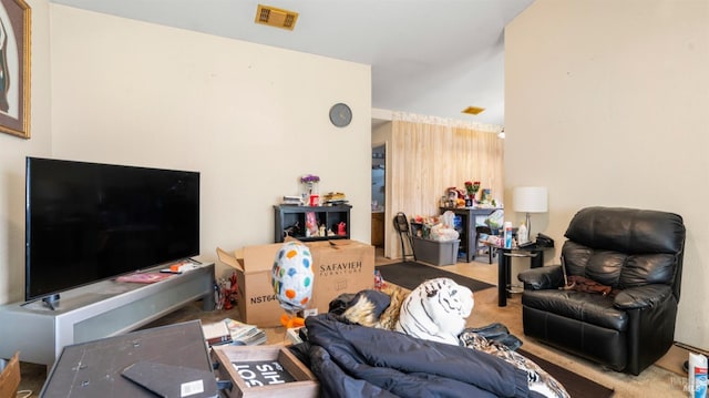 carpeted living area featuring visible vents