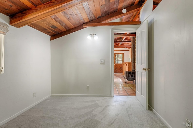 unfurnished room with wood ceiling, light carpet, baseboards, and vaulted ceiling with beams