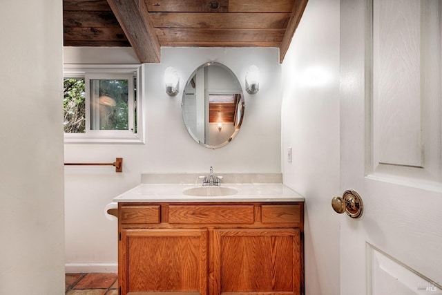 bathroom with beamed ceiling, vanity, baseboards, and wooden ceiling