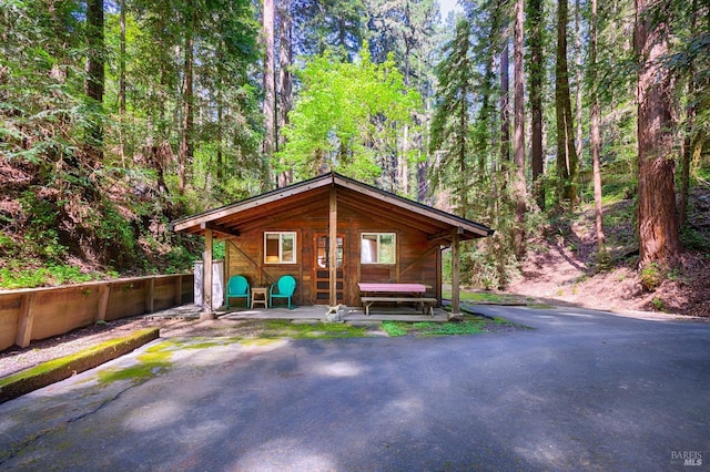 exterior space featuring a wooded view