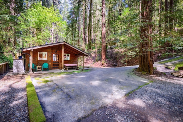 view of side of property featuring a wooded view