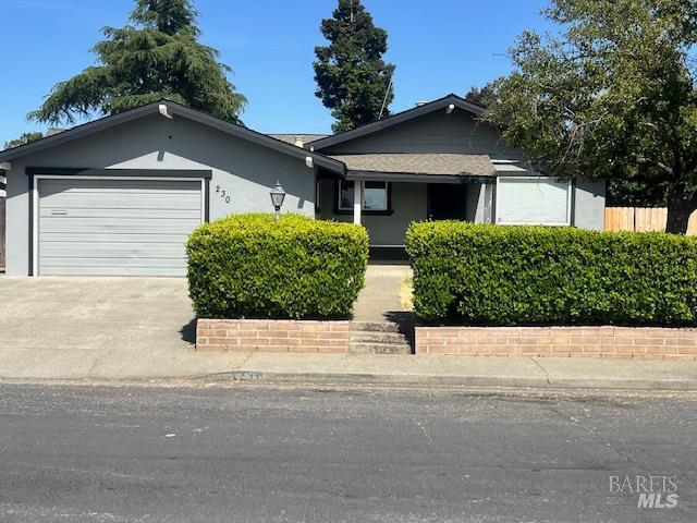 230 Lawrence St, Fairfield, CA 94533 - view of front facade featuring an attached garage, driveway, and stucco siding